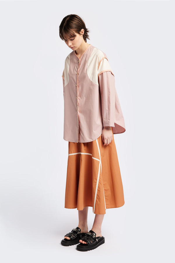 Front of The Ages shirt in peach, a Patchwork-style shirt with block colours, bound seams, rounded neckline, centre front button opening, and rounded hemline, offering a relaxed, modern fit