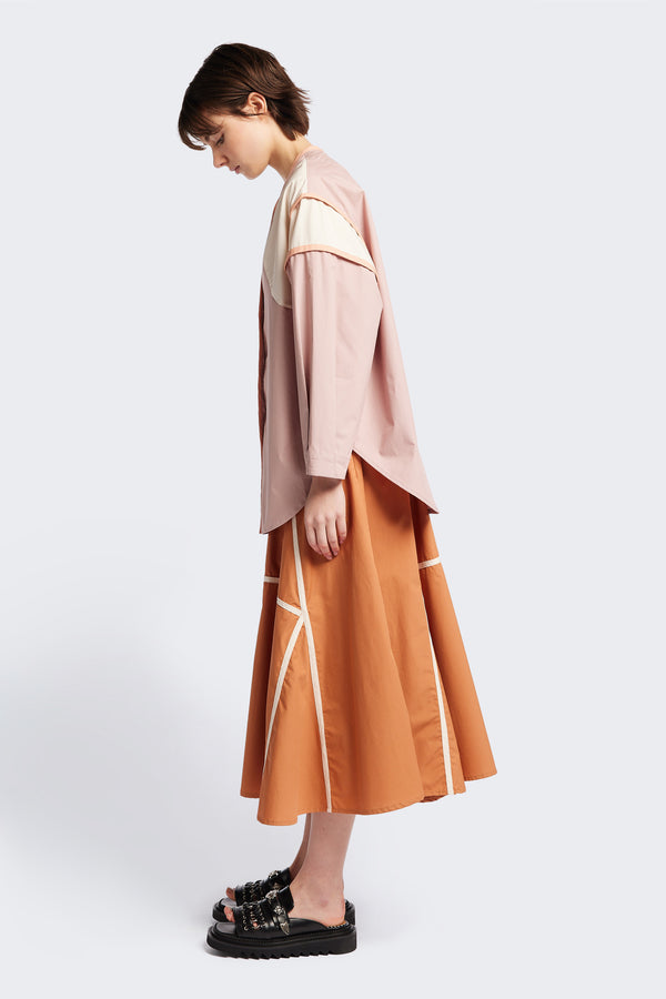 Side of The Ages shirt in peach, a Patchwork-style shirt with block colours, bound seams, rounded neckline, centre front button opening, and rounded hemline, offering a relaxed, modern fit