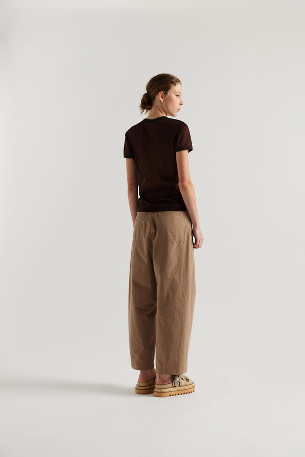 Back of the model in the Fawn brown Amber Pant. A Semi-tailored tapered pant with pleat waistband detail and front seam topstitching.