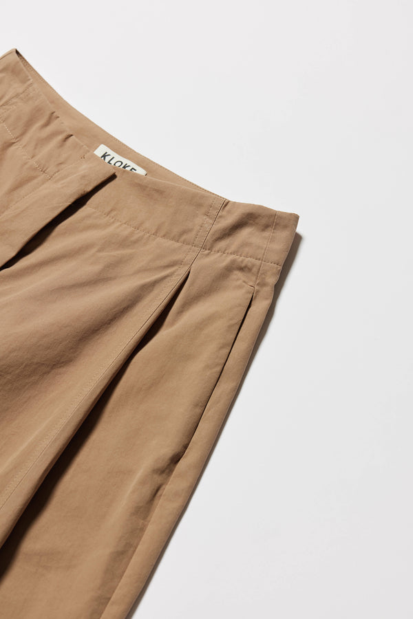 Close-up of waistband showing narrow finish and hook-and-bar closure.