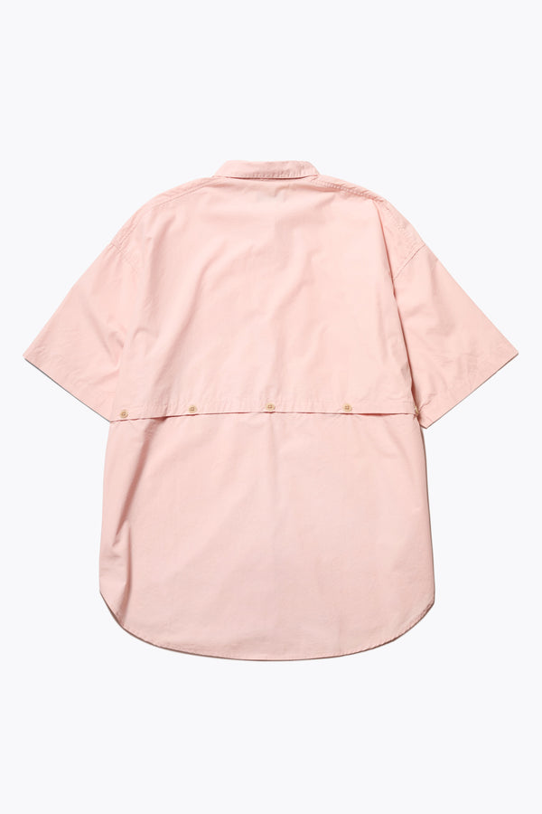 Flat Front of the Aquifer in peach, a relaxed loose-fitting boxy short-sleeve shirt with back button placket, scoop hemline, and chest patch pockets, crafted in lightweight cotton poplin. Available in 5 sizes. 