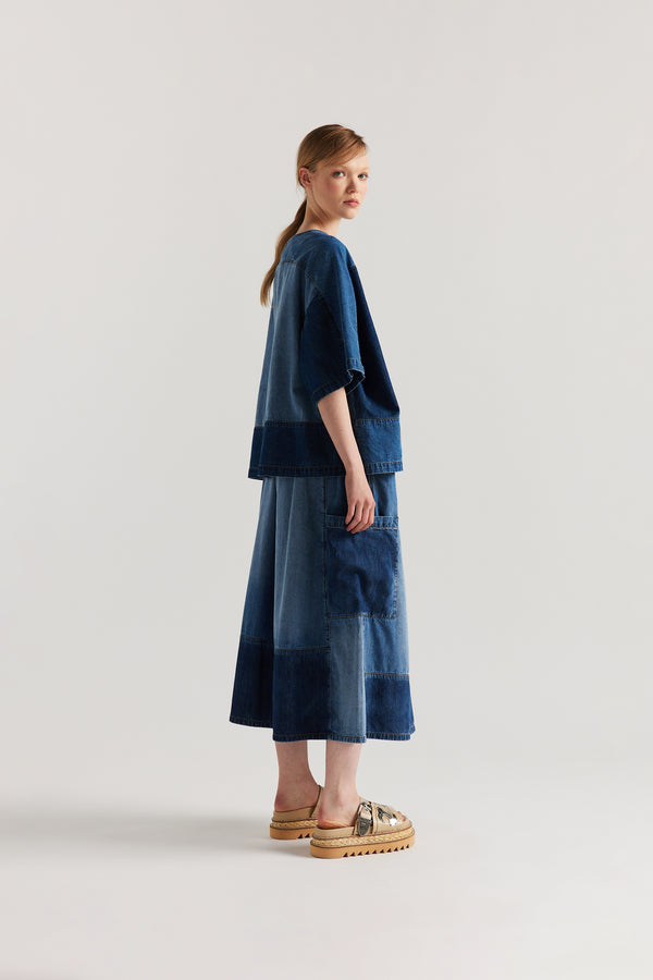 Back side view of Dark/Mid Blue Fade Aria Panel Skirt showing panelled denim construction, scoop pockets, and elasticated waistband.