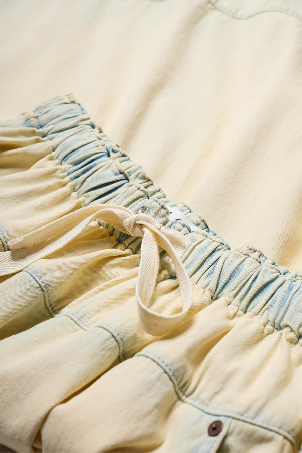 Close-up of Aria Panel Skirt lasticated waistband and showcasing colour-faded denim.