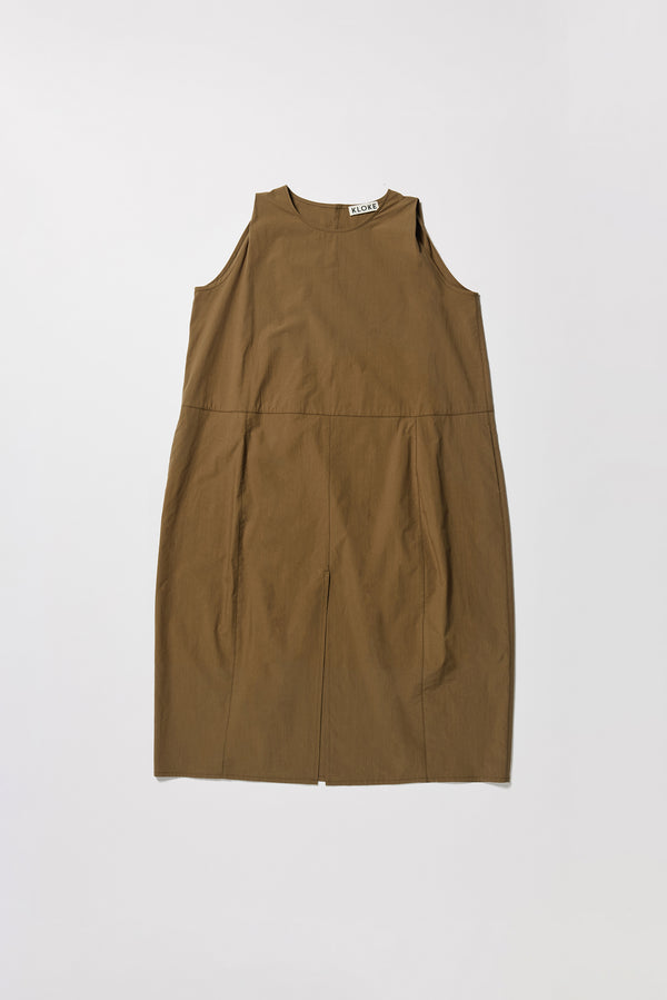 Flat front of the olive  Aureole Dress front view showing panelled detailing and relaxed skirt with front inseam split