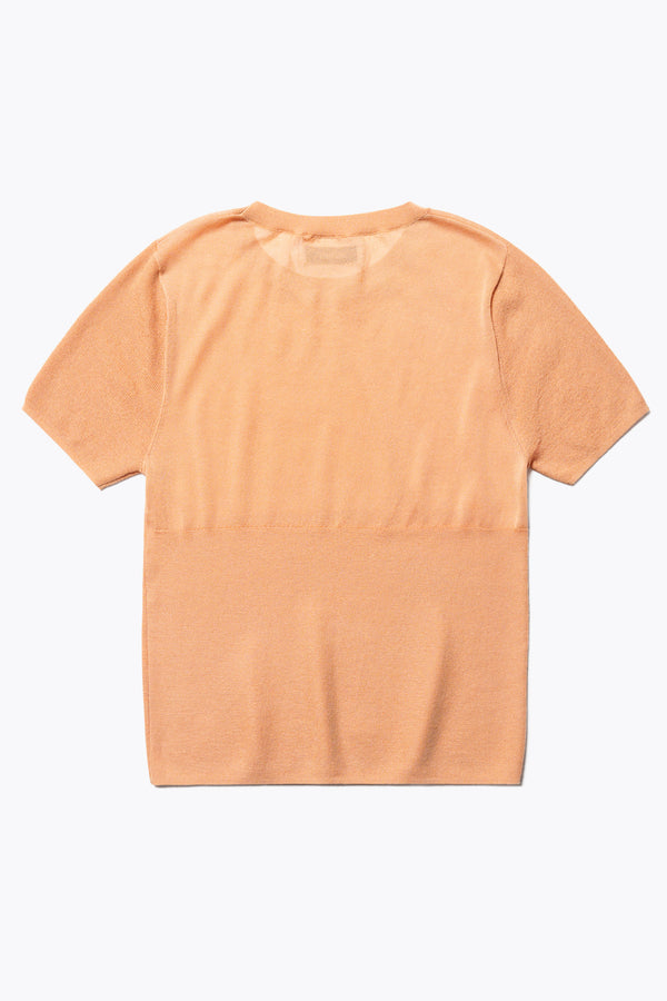 Flat back of The Break Knit Top in pale orange, crafted from fine-gauge cotton. Features a crew neckline, short sleeves, and a slim fit with a high rib detail below the chest.