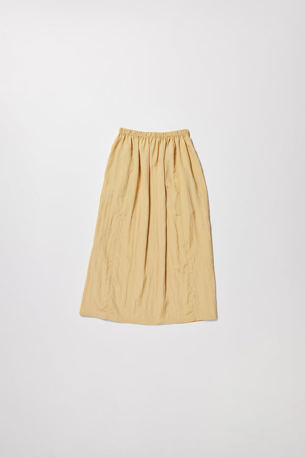 Flat back of the beige Calm Skirt with panelled construction, scoop pockets and elasticated drawcord waistband in lightweight textured fabric.