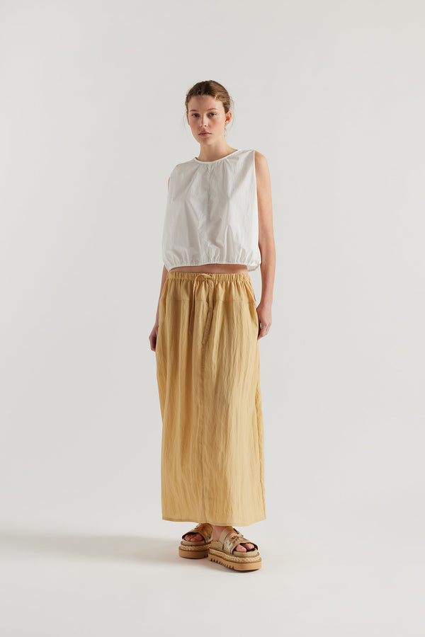 Front of Model in the beige Calm Skirt with panelled construction, scoop pockets and elasticated drawcord waistband in lightweight textured fabric.