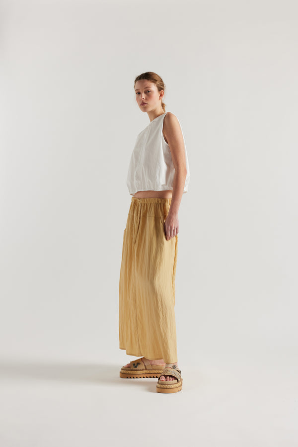 Front of Model in the beige Calm Skirt with panelled construction, scoop pockets and elasticated drawcord waistband in lightweight textured fabric.