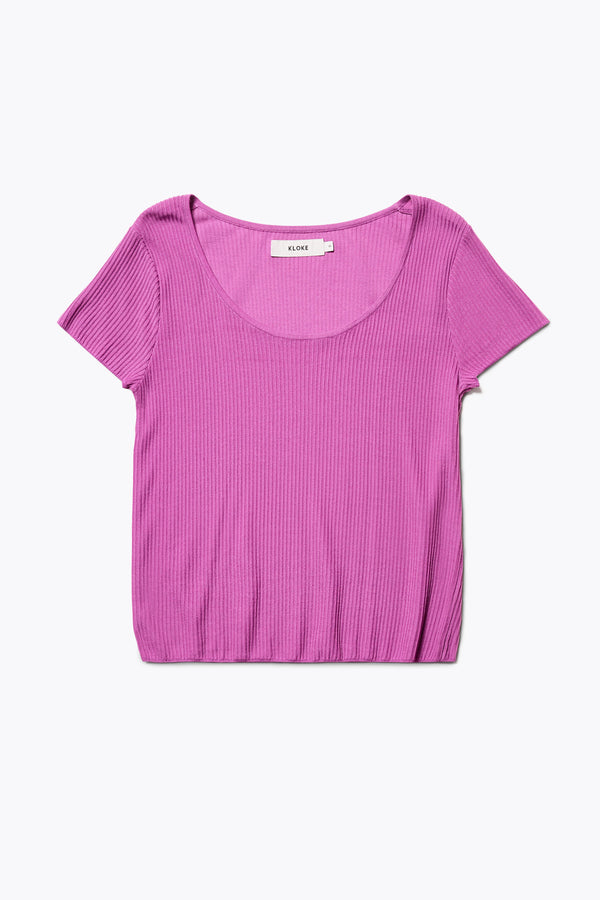 Celsius Knit T-Shirt in Fuchsia Pink, ribbed with a shallow scoop neckline, small cap sleeves, and slim fit. Made from 100% Tencel. Available in 5 sizes. 