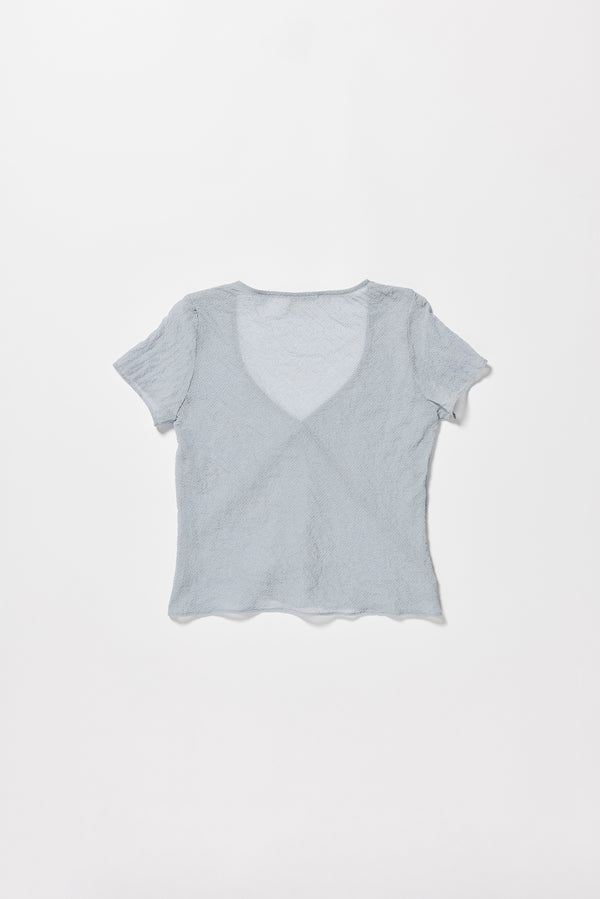 Flat back of the Pale Blue Centered top. A Slim-fit V-neck top in sheer textured fabric with cap sleeves and bias cut silhouette.
