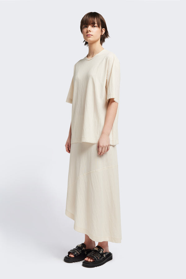 Front of the Chaise top in Ecru, a relaxed crew-neck top in a Japanese rayon blend with short sleeves, boxy fit, raw hemline, and exposed seam detail across the mid-back.