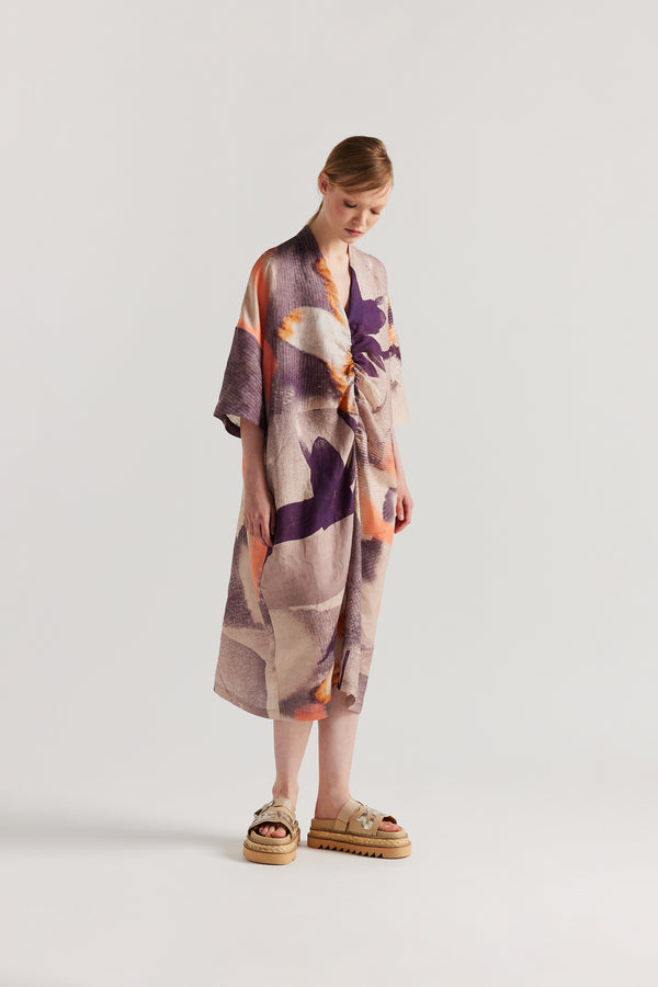 Front angle of model wearing the Chaos dress a relaxed V-neck linen dress in the Kloke Custom Chaos print, gathered at the centre front.  