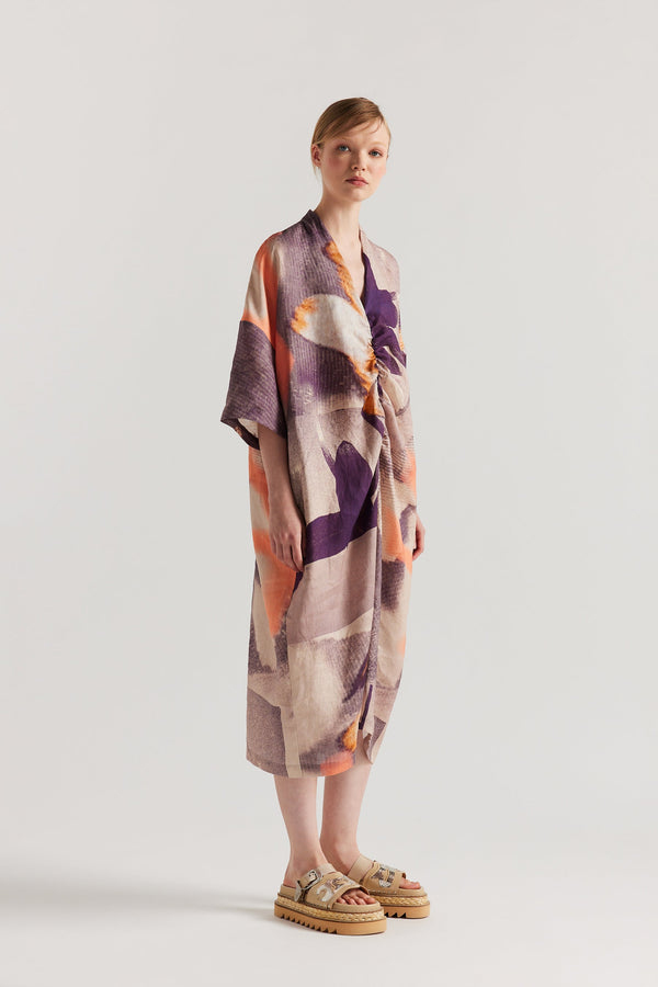 Front angle of model wearing the Chaos dress a relaxed V-neck linen dress in the Kloke Custom Chaos print, gathered at the centre front.  
