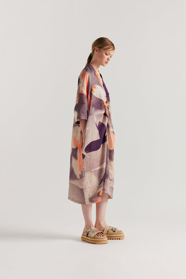 Side of model wearing the Chaos dress a relaxed V-neck linen dress in the Kloke Custom Chaos print, gathered at the centre front.  