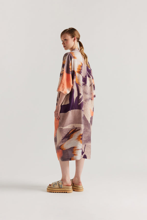 Back of model wearing the Chaos dress a relaxed V-neck linen dress in the Kloke Custom Chaos print, gathered at the centre front.  