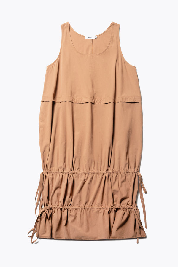 Flat front of the cloud dress in toffee brown, a relaxed-fit sleeveless dress with wide shoulder straps, a scoop neckline.