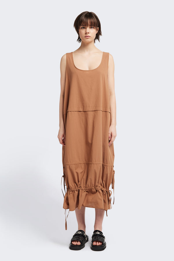 Front view of the cloud dress in toffee brown, a relaxed-fit sleeveless dress featuring wide shoulder straps and a scoop neckline.