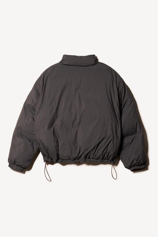 Flat Front of the Transform Puffa Jacket black side, showcasing full sleeves, cropped length and high collar