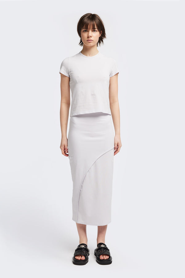 Front view of The Cumulus Skirt in white ice blue. A Slim, mid-calf dress in a cotton blend with stretch, featuring a curved bound seam for a flattering silhouette.