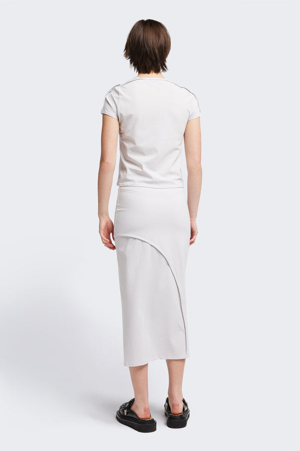 Back view of The Cumulus Skirt in white ice blue. A Slim, mid-calf dress in a cotton blend with stretch, featuring a curved bound seam for a flattering silhouette.