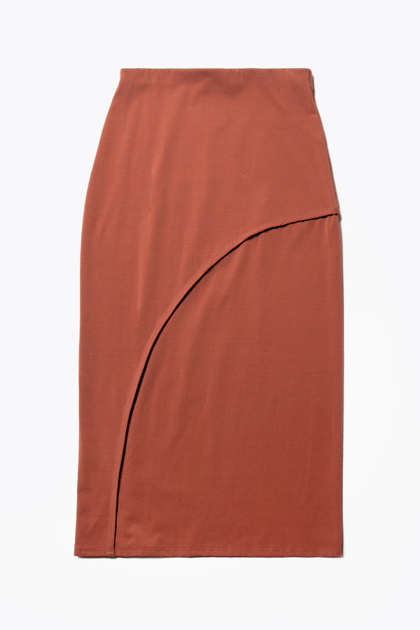 Flat Front view of The Cumulus Skirt in brick red. A Slim, mid-calf dress in a cotton blend with stretch, featuring a curved bound seam for a flattering silhouette.