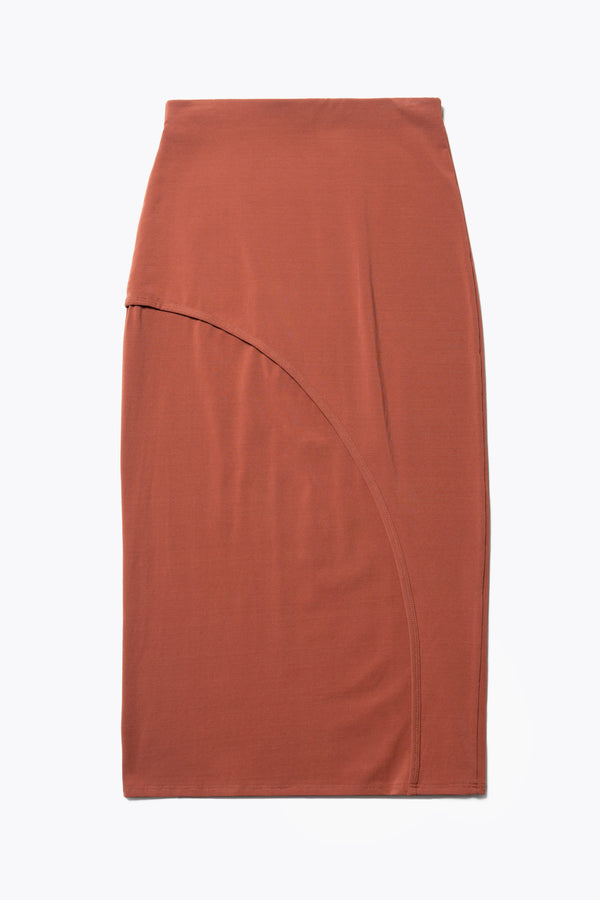 Flat Back view of The Cumulus Skirt in brick red. A Slim, mid-calf dress in a cotton blend with stretch, featuring a curved bound seam for a flattering silhouette.