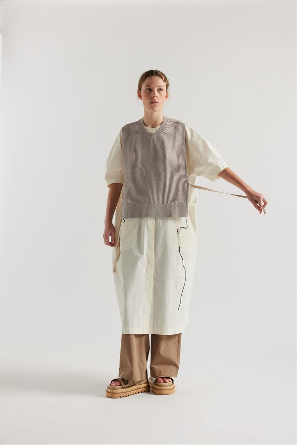 Cusp Knit Vest in dove grey, front view on model, featuring herringbone ties and half-cardigan knit construction.