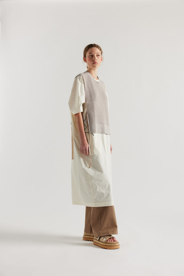 Cusp Knit Vest in dove grey, side view on model, featuring herringbone ties and half-cardigan knit construction.