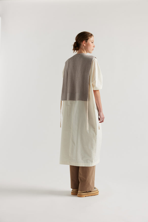 Cusp Knit Vest in dove grey, back view on model, featuring herringbone ties and half-cardigan knit construction.