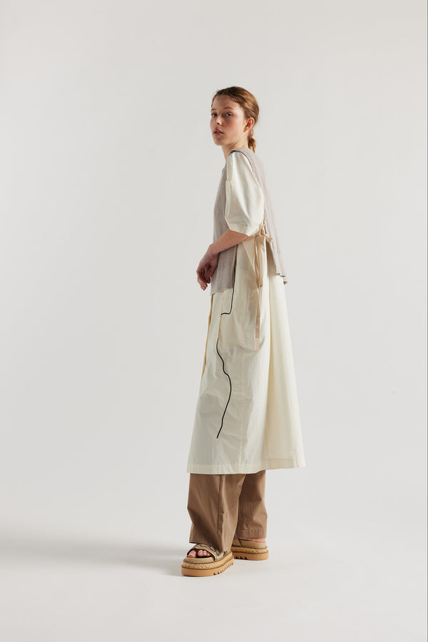 Cusp Knit Vest in dove grey, side view on model, featuring herringbone ties and half-cardigan knit construction.