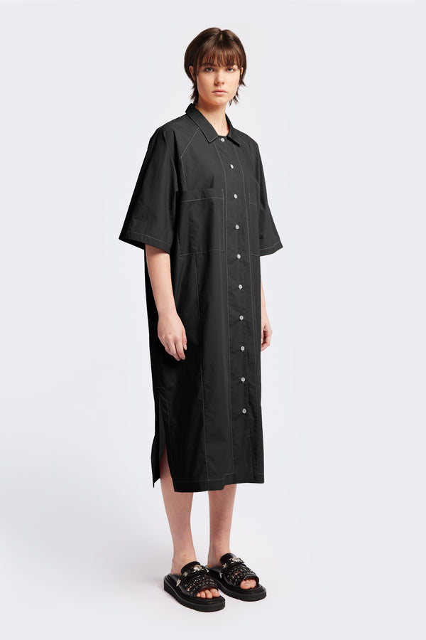 The Daily Shirt Dress is a midi-length, oversized and relaxed style with elbow grazing sleeves. Featuring tall side slits for ease of movement. Made from all natural cotton in black with white contrast topstitch.