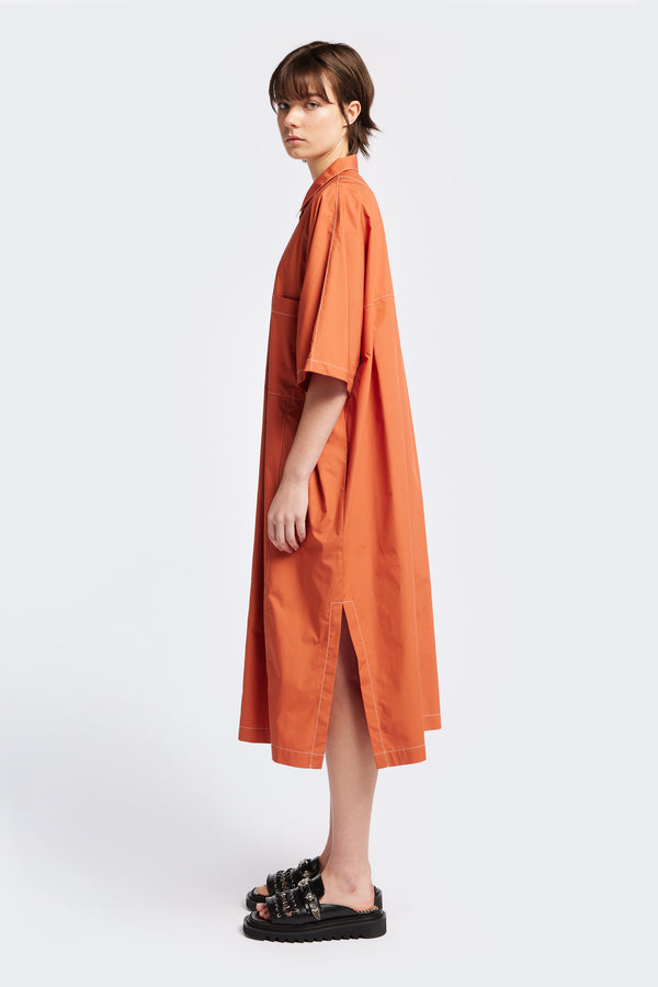 The Daily Dress is a midi-length, oversized and relaxed dress with wide, elbow grazing sleeves and tall side slits for ease of movement. Made from an all natural-cotton in Rust.