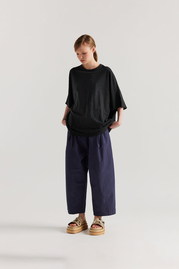 Front view of model in the Jet Balck Declare Tee in pigment-dyed slub cotton with relaxed boxy fit 