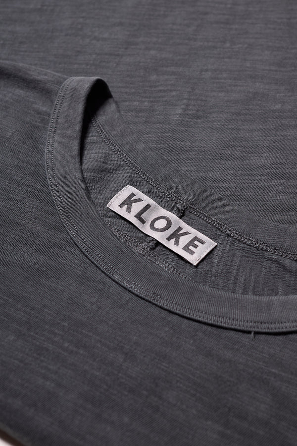 Close up fabric shot of the Jet Black Declare Tee in pigment-dyed slub cotton with relaxed boxy fit 