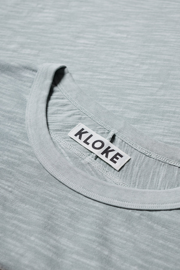 Close up fabric shot of the Pale Blue Declare Tee in pigment-dyed slub cotton with relaxed boxy fit 
