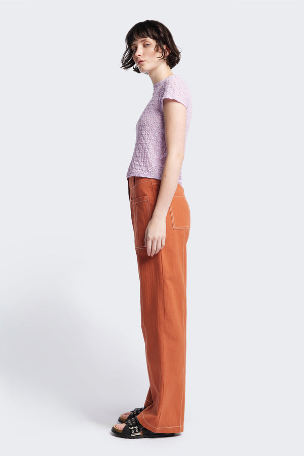 Side view of the Delta pant in Burnt Orange, a tailored casual pant in premium cotton herringbone twill with contrast stitch panelling. Straight leg and tailored fit for a sleek, flattering polished finish. Available in 6 sizes. 