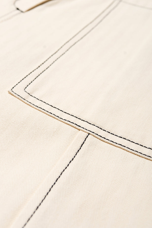 Close up Fabric view of the Delta pant in Ecru Beige, a tailored casual pant in premium cotton herringbone twill with contrast stitch panelling. Straight leg and tailored fit for a sleek, flattering polished finish. Available in 6 sizes. 