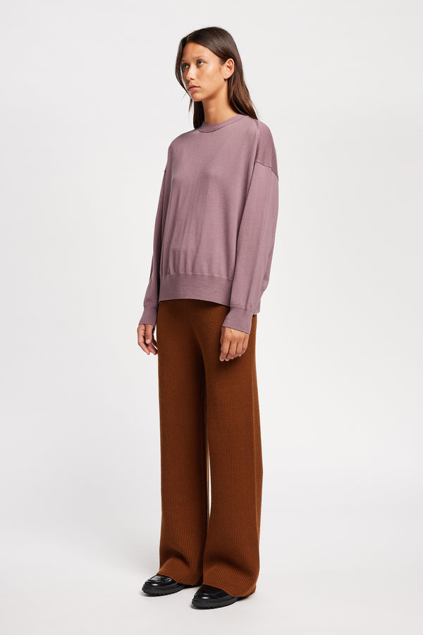 Front angle view on Model of the Descend Loose Fit Merino Knit in Mauve, a relaxed-fit merino wool sweater with a crew neck. 
