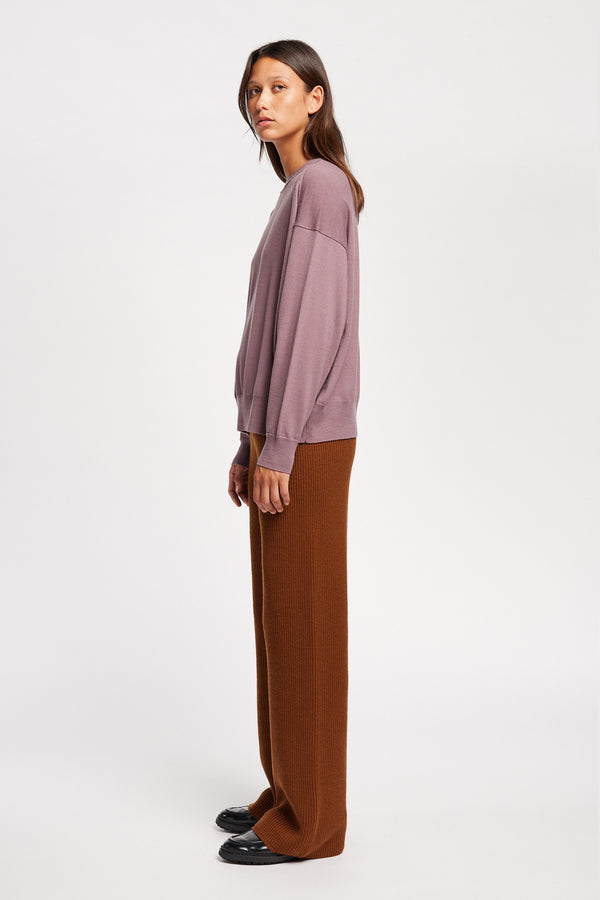 Side view on Model of the Descend Loose Fit Merino Knit in Mauve relaxed-fit merino wool sweater with a crew neck. 