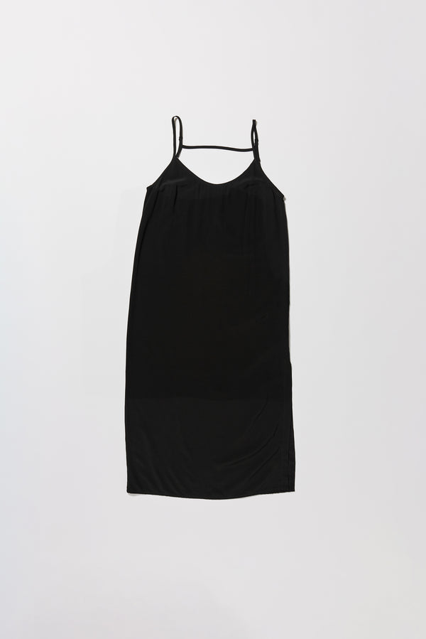 Flat front of black Mid-length slip dress with straight neckline and relaxed silhouette