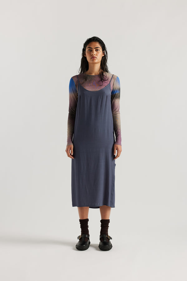 Front of female model indigo blue Mid-length slip dress with straight neckline and relaxed silhouette
