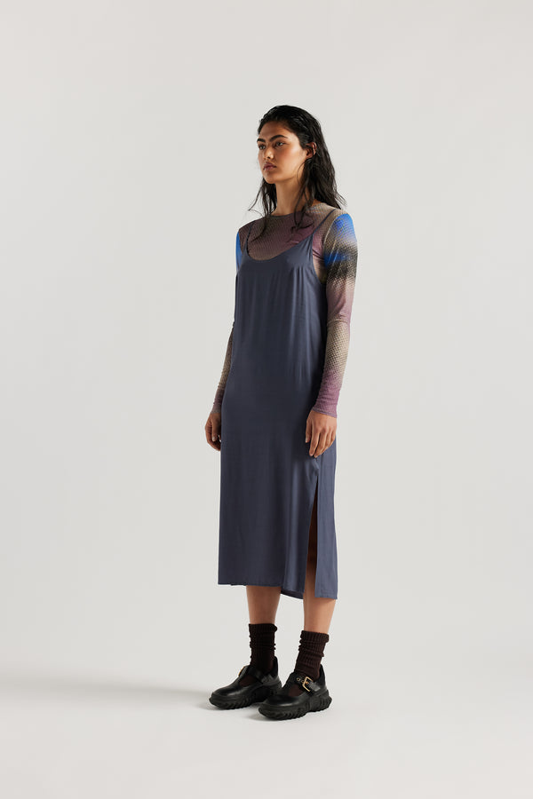 Front of female model indigo blue Mid-length slip dress with straight neckline and relaxed silhouette