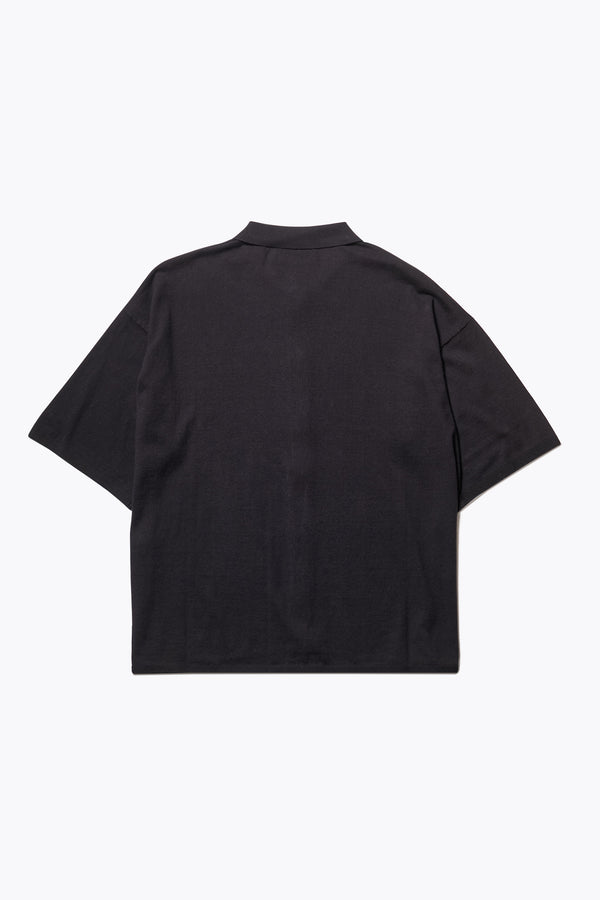 The back of the Escalade Knit Shirt in Black, a relaxed knit short sleeve shirt with a button placket and straight collar, made from premium soft, summer-weight combed cotton. Textured knit construction, available in 5 sizes.