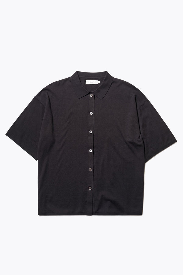 Escalade Knit Shirt in Black, a relaxed knit short sleeve shirt with a button placket and straight collar, made from premium soft, summer-weight combed cotton. Textured knit construction, available in 5 sizes.