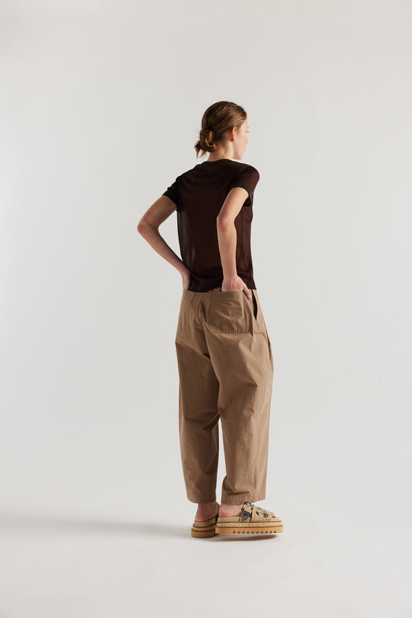 Back view on female model of the slim-fit sheer knit tee with ringer neckline in brown. 