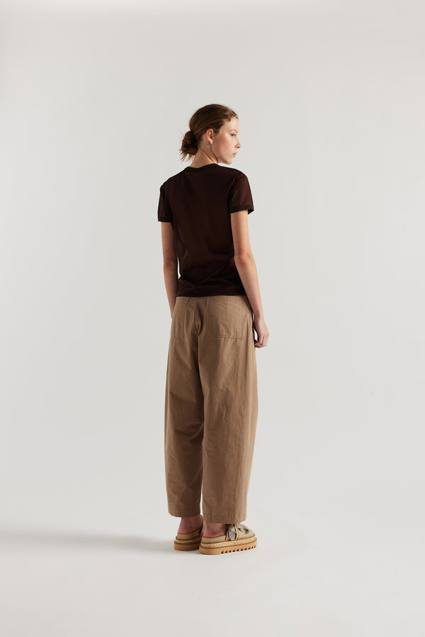 Back view on female model of the slim-fit sheer knit tee with ringer neckline in brown. 