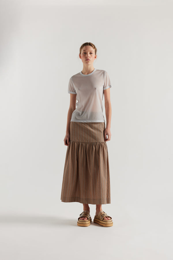 Front view on female model of the slim-fit sheer knit tee with ringer neckline in Pale Blue. 