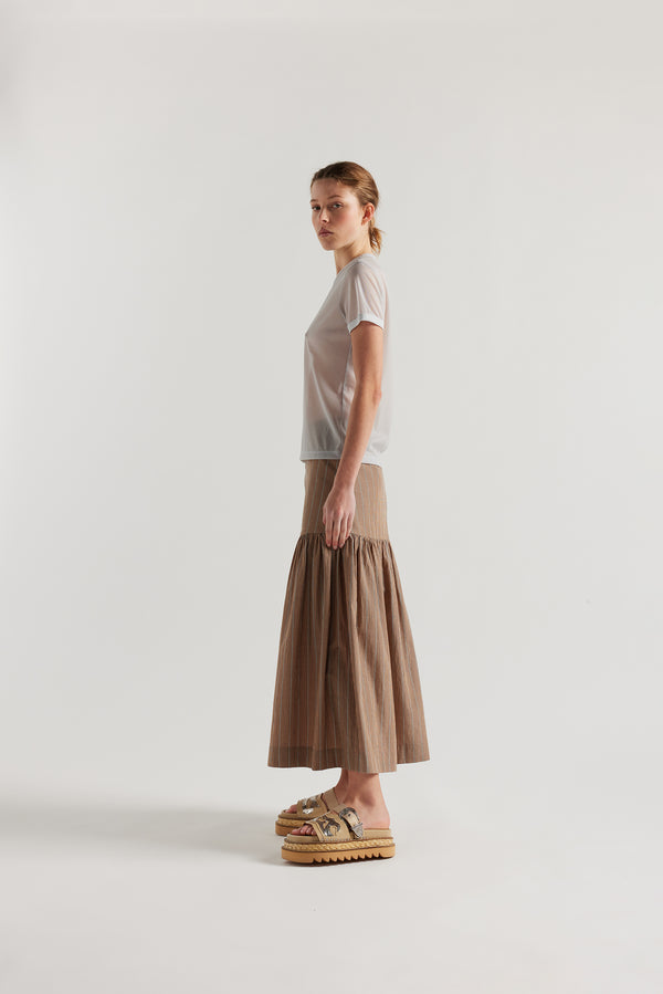 Side view on female model of the slim-fit sheer knit tee with ringer neckline in Pale Blue. 