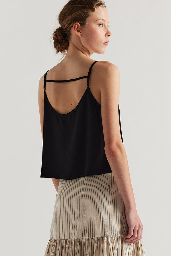 Back view on model of black Viscose rayon Evolve Top with adjustable straps and fluid drape