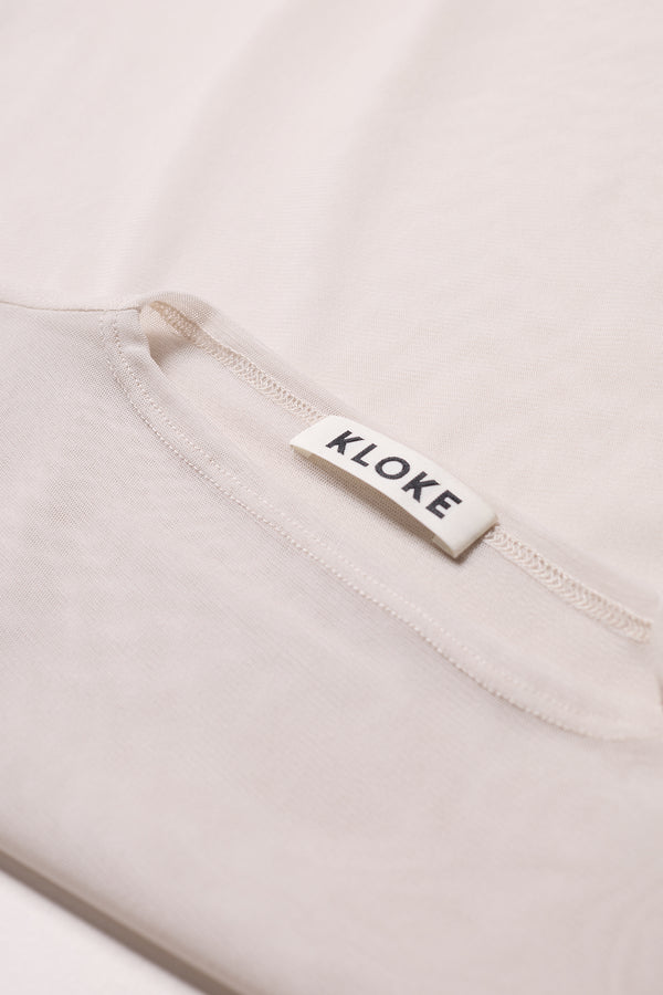 Close-up of the Exist Top’s Japanese power-mesh texture and fine detailing in Bone Cream